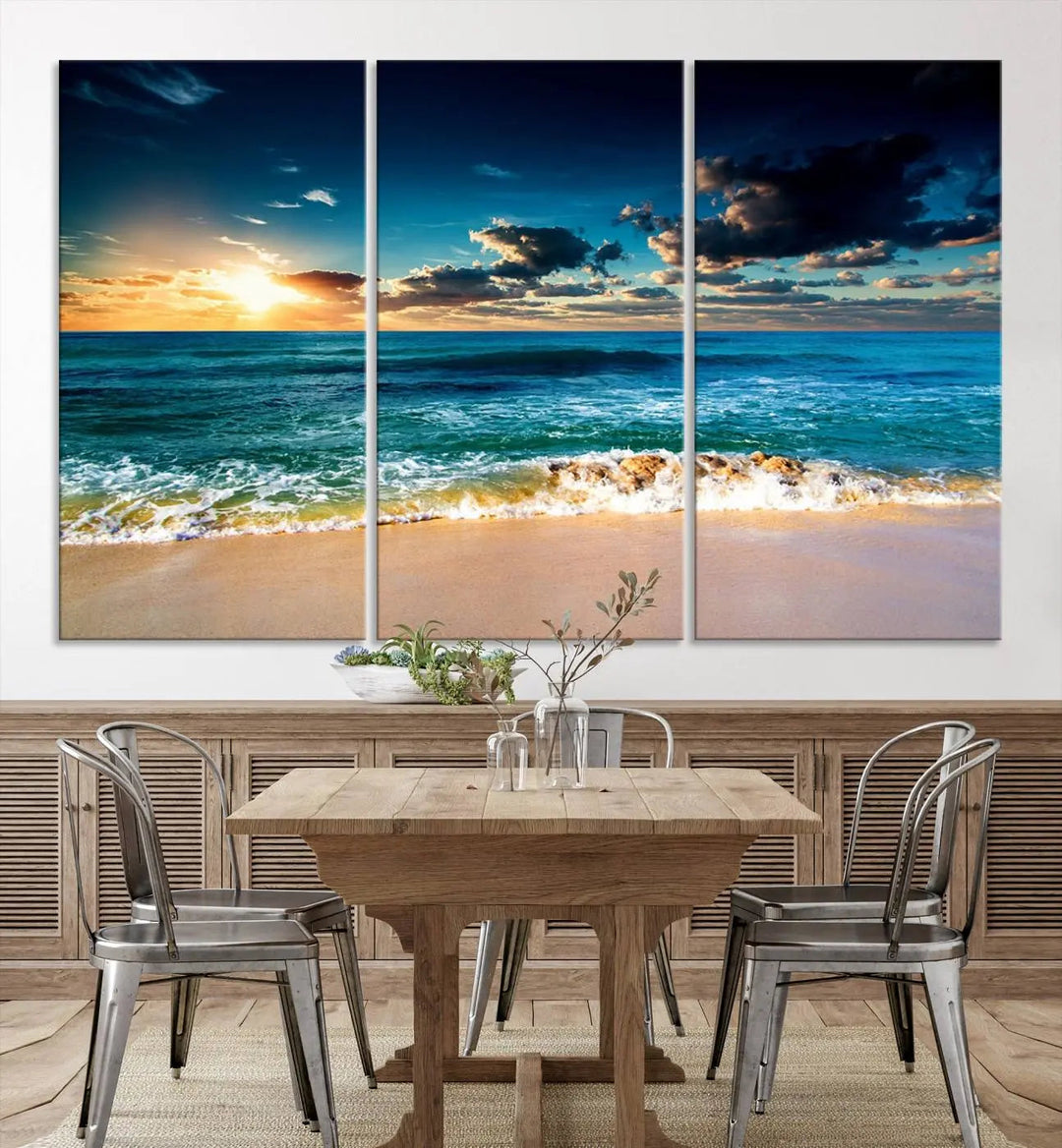 The Ocean Breeze Beach Sunset Wall Art Canvas Print—a captivating triptych of a beach sunset—adds a stunning coastal charm to the room, making it ideal for home or cabin decor.