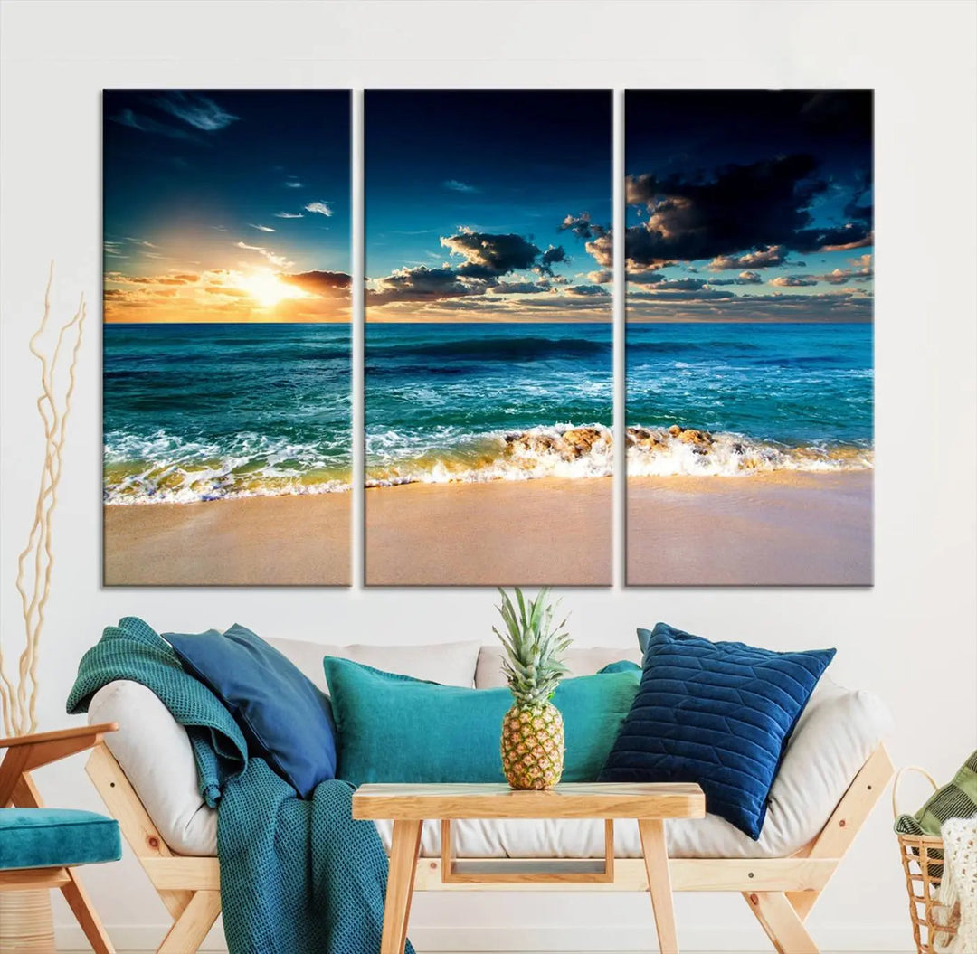 The Ocean Breeze Beach Sunset Wall Art Canvas Print—a captivating triptych of a beach sunset—adds a stunning coastal charm to the room, making it ideal for home or cabin decor.