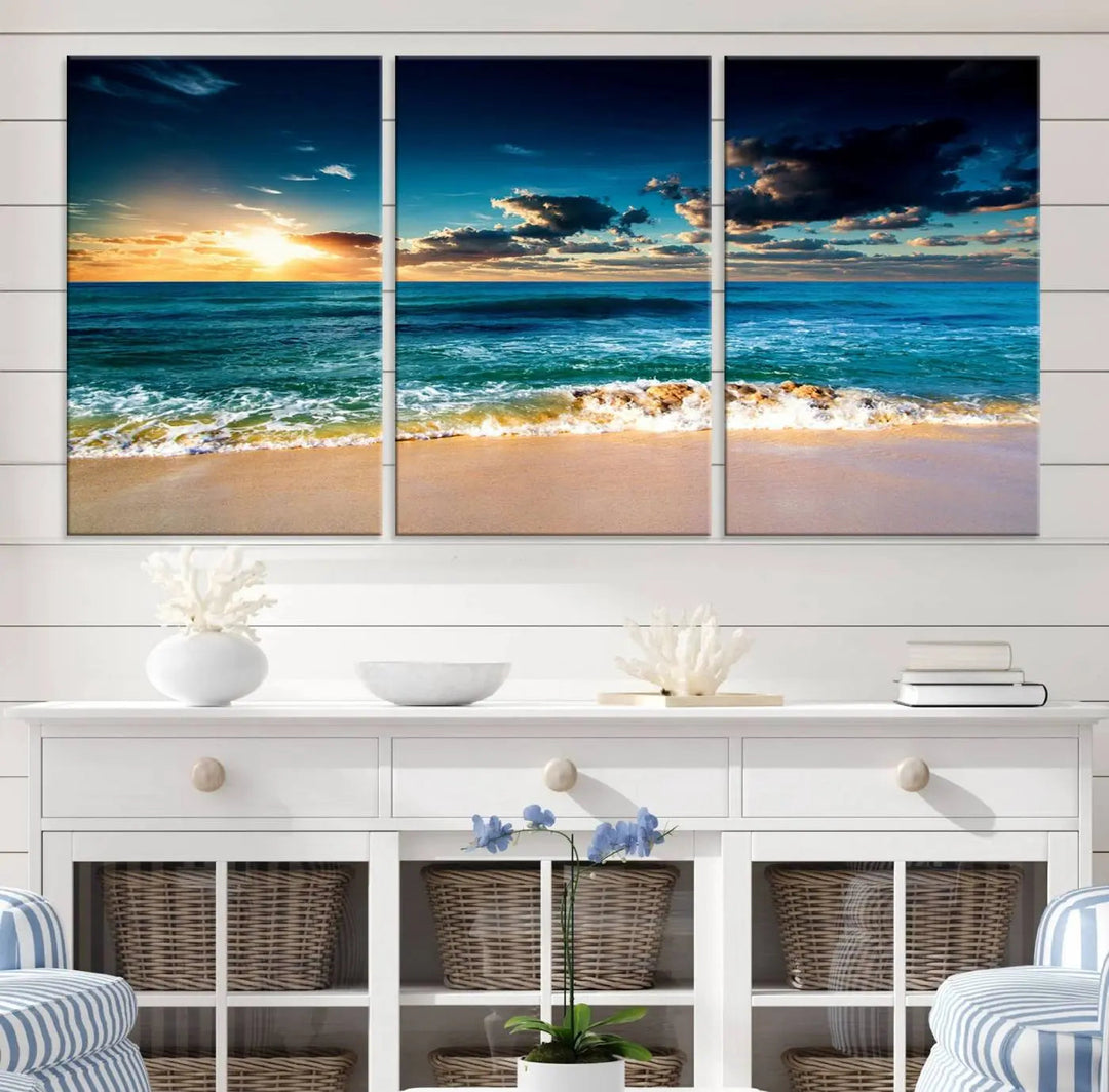 The Ocean Breeze Beach Sunset Wall Art Canvas Print—a captivating triptych of a beach sunset—adds a stunning coastal charm to the room, making it ideal for home or cabin decor.