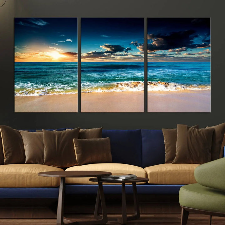 The Ocean Breeze Beach Sunset Wall Art Canvas Print—a captivating triptych of a beach sunset—adds a stunning coastal charm to the room, making it ideal for home or cabin decor.