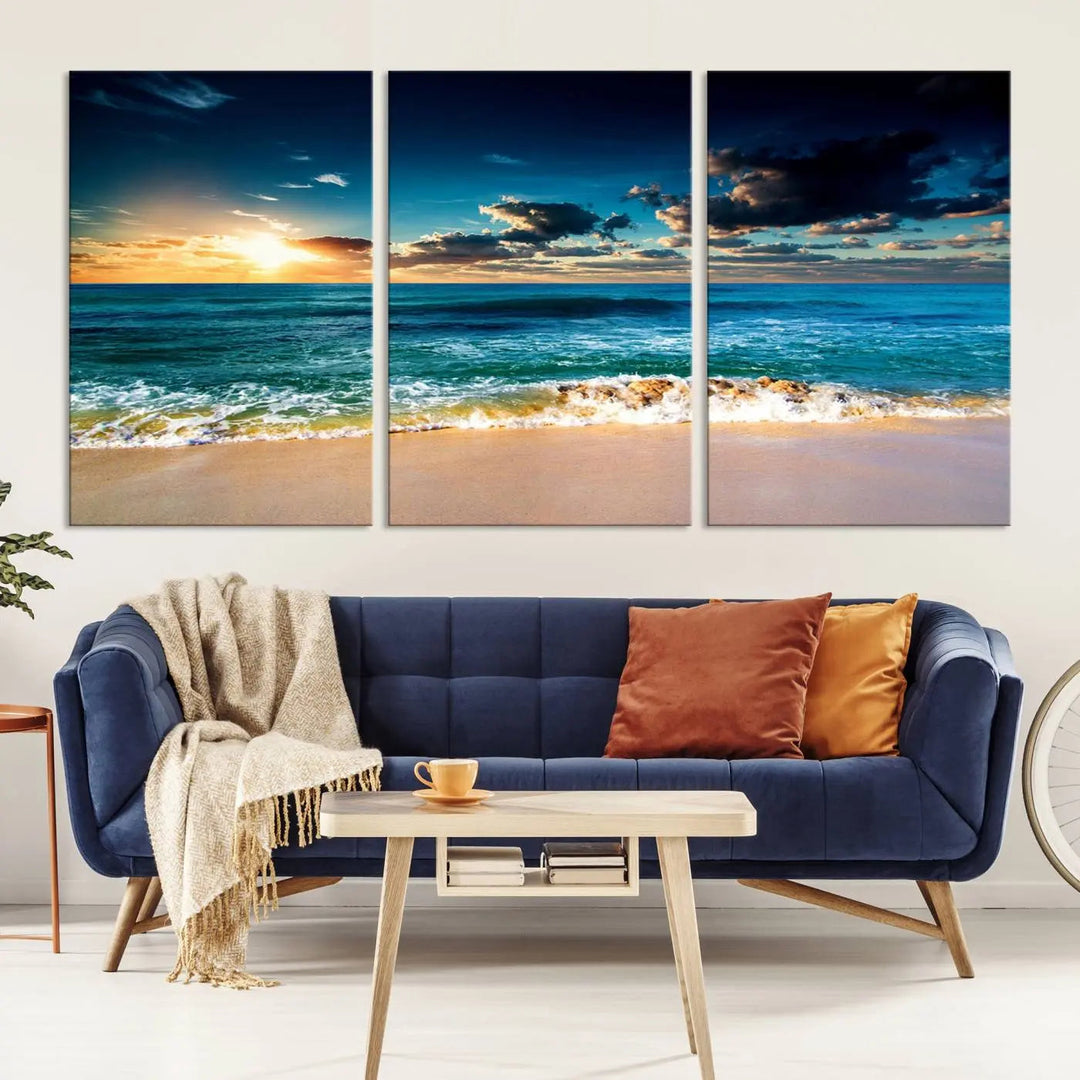 The Ocean Breeze Beach Sunset Wall Art Canvas Print—a captivating triptych of a beach sunset—adds a stunning coastal charm to the room, making it ideal for home or cabin decor.