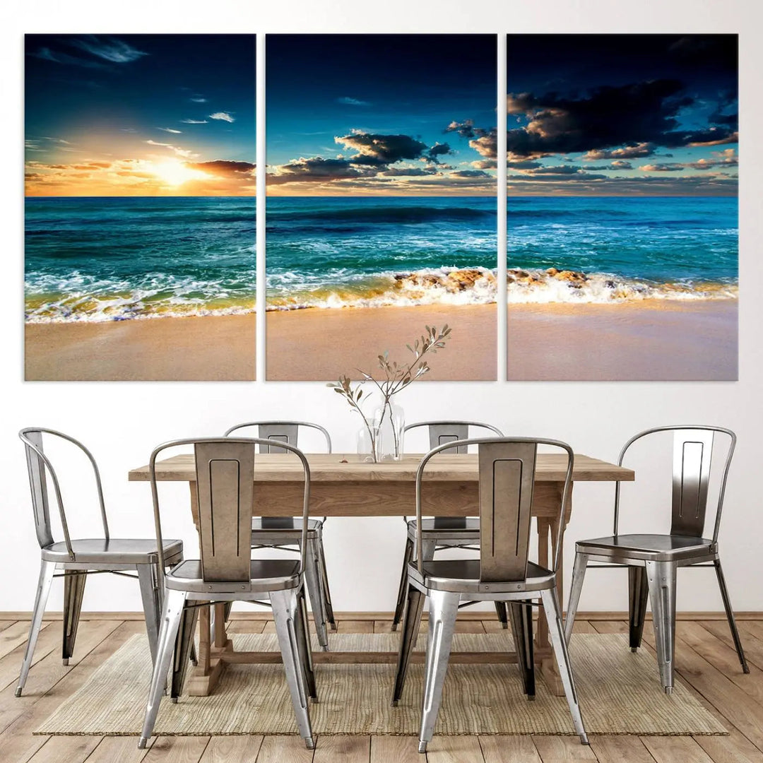 The Ocean Breeze Beach Sunset Wall Art Canvas Print—a captivating triptych of a beach sunset—adds a stunning coastal charm to the room, making it ideal for home or cabin decor.