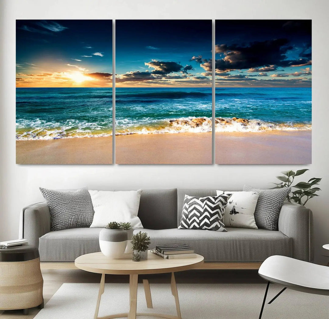 The Ocean Breeze Beach Sunset Wall Art Canvas Print—a captivating triptych of a beach sunset—adds a stunning coastal charm to the room, making it ideal for home or cabin decor.