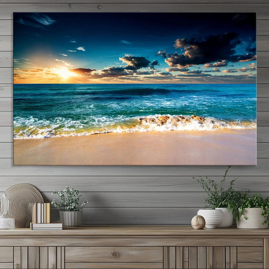 The Ocean Breeze Beach Sunset Wall Art Canvas Print—a captivating triptych of a beach sunset—adds a stunning coastal charm to the room, making it ideal for home or cabin decor.