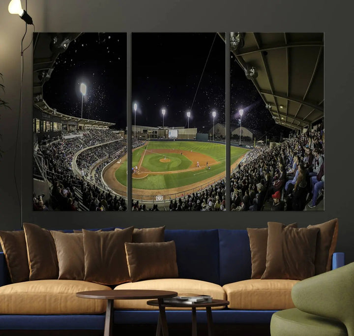 The living room is accentuated by the gallery-quality finish of a stunning three-panel canvas, the "Olsen Field at Blue Bell Park - Texas A&M Aggies Baseball Stadium Wall Art Canvas Print," beautifully depicting a baseball stadium at night.