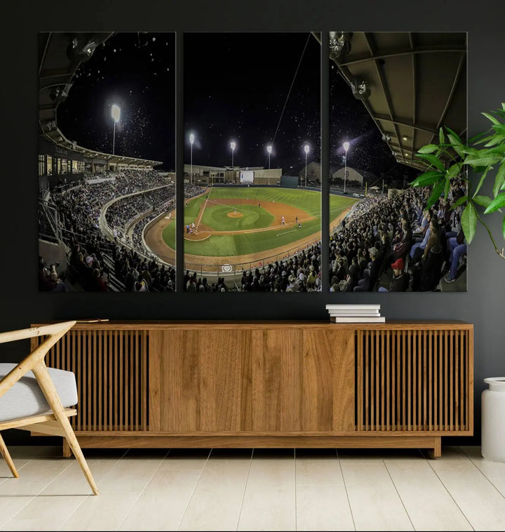 The living room is accentuated by the gallery-quality finish of a stunning three-panel canvas, the "Olsen Field at Blue Bell Park - Texas A&M Aggies Baseball Stadium Wall Art Canvas Print," beautifully depicting a baseball stadium at night.