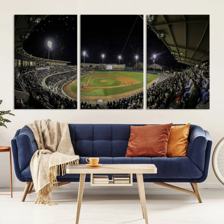 The living room is accentuated by the gallery-quality finish of a stunning three-panel canvas, the "Olsen Field at Blue Bell Park - Texas A&M Aggies Baseball Stadium Wall Art Canvas Print," beautifully depicting a baseball stadium at night.