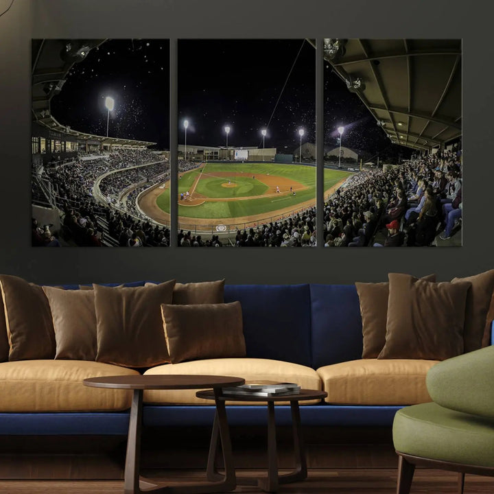 The living room is accentuated by the gallery-quality finish of a stunning three-panel canvas, the "Olsen Field at Blue Bell Park - Texas A&M Aggies Baseball Stadium Wall Art Canvas Print," beautifully depicting a baseball stadium at night.