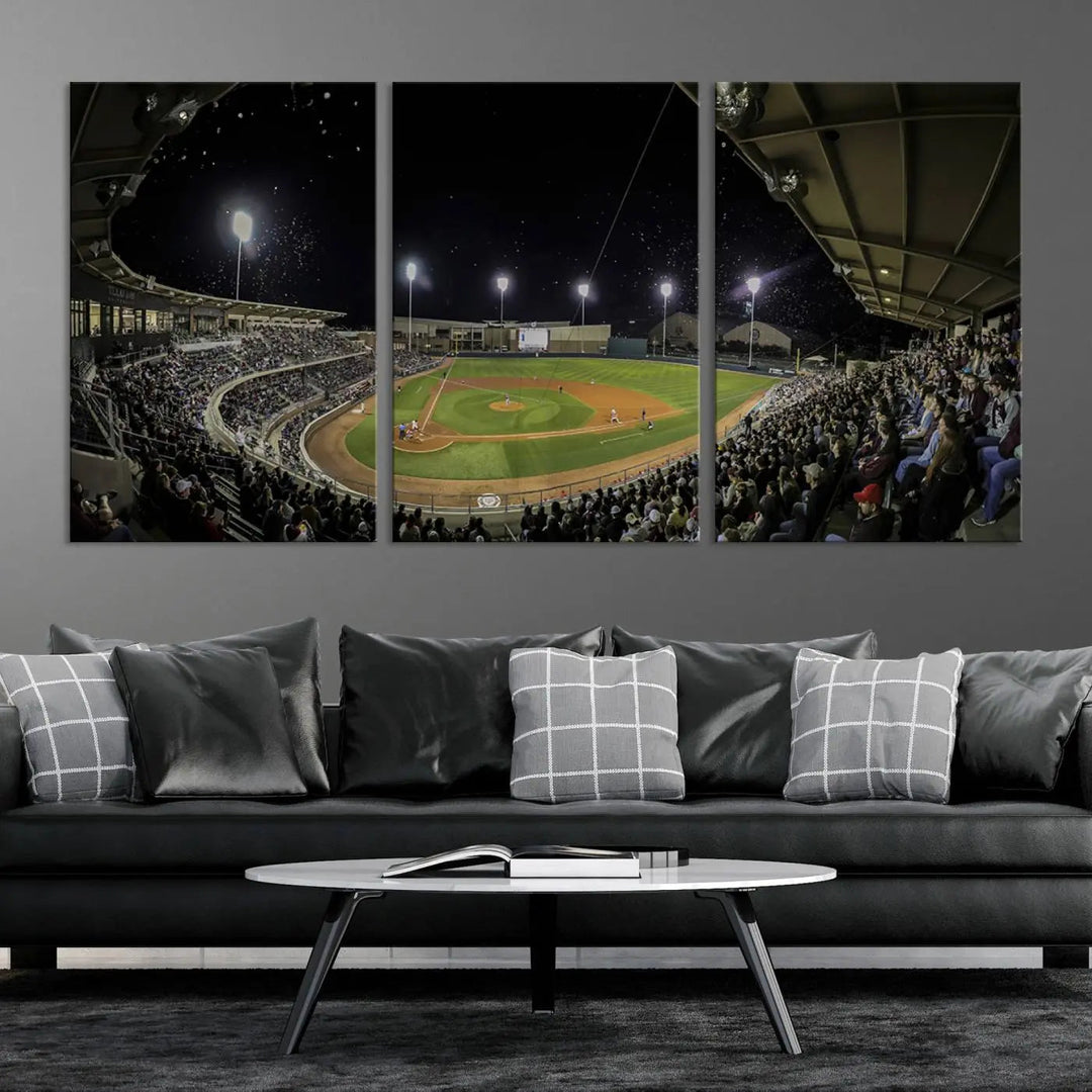 The living room is accentuated by the gallery-quality finish of a stunning three-panel canvas, the "Olsen Field at Blue Bell Park - Texas A&M Aggies Baseball Stadium Wall Art Canvas Print," beautifully depicting a baseball stadium at night.