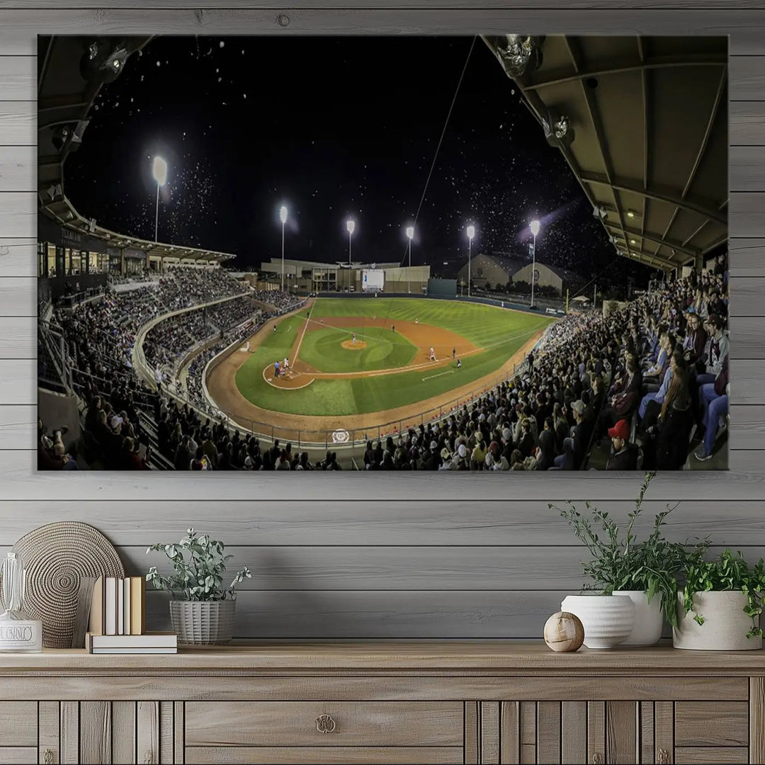 The living room is accentuated by the gallery-quality finish of a stunning three-panel canvas, the "Olsen Field at Blue Bell Park - Texas A&M Aggies Baseball Stadium Wall Art Canvas Print," beautifully depicting a baseball stadium at night.