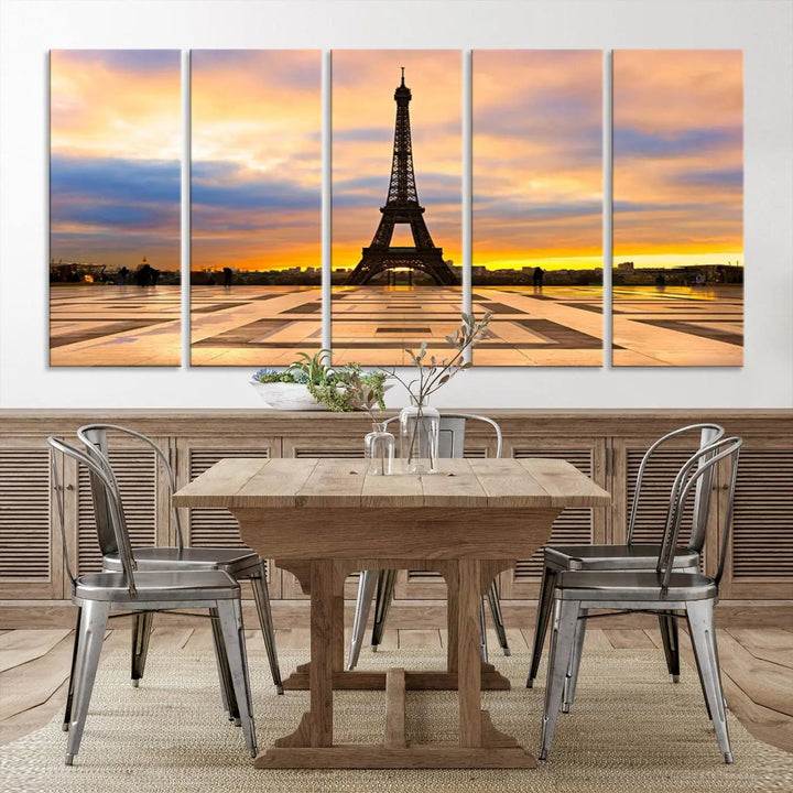 A captivating Paris Eiffel Tower Sunset Canvas Wall Art Print, featuring vibrant colors and showcasing the iconic landmark, is elegantly displayed in a frame on a wooden wall.