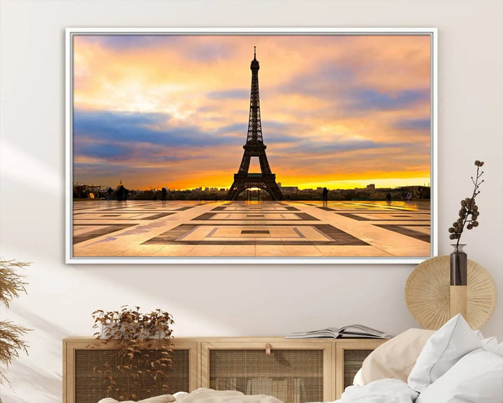 A captivating Paris Eiffel Tower Sunset Canvas Wall Art Print, featuring vibrant colors and showcasing the iconic landmark, is elegantly displayed in a frame on a wooden wall.