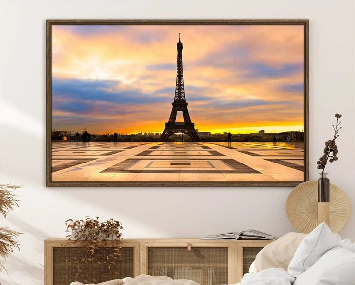 A captivating Paris Eiffel Tower Sunset Canvas Wall Art Print, featuring vibrant colors and showcasing the iconic landmark, is elegantly displayed in a frame on a wooden wall.