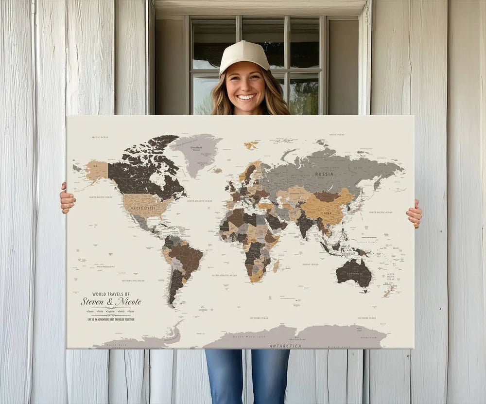 A large framed Personalized World Map Wall Art Canvas Print features custom text at the bottom, perfect for travel and exploration enthusiasts.