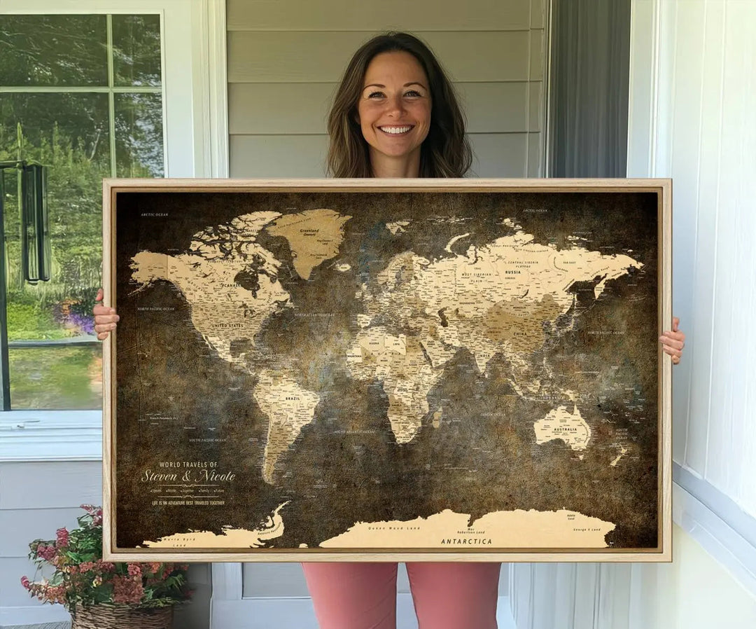 A woman beams with joy as she holds a large framed Personalized World Map Wall Art, capturing the essence of adventure and wanderlust.