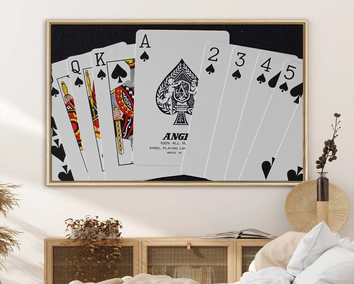 The Poker Wall Art - Playing Cards Canvas Wall Art Print features an Ace of Spades and Royal Flush design. This piece adds a classic charm to any space with its subtle emphasis on the Ace of Spades, making it perfect for game room decor.