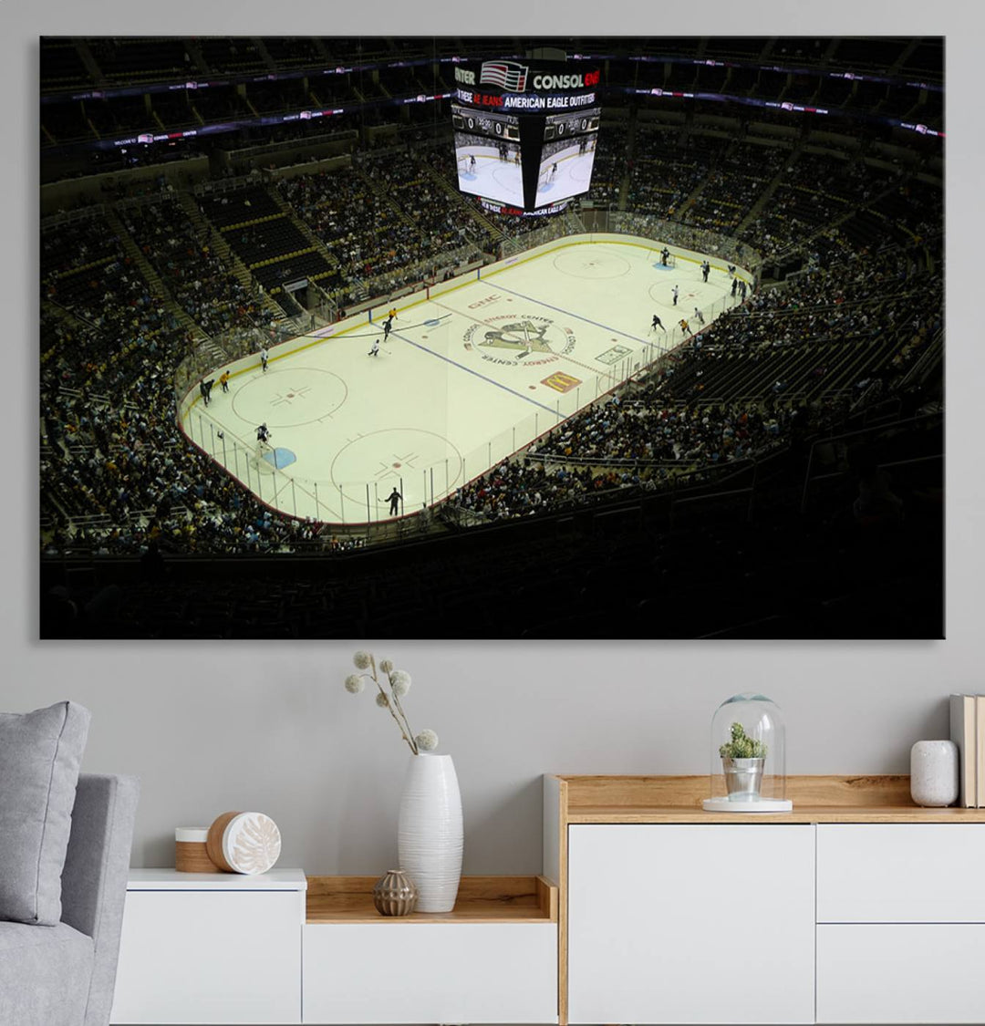 This museum-quality canvas captures a stunning aerial view of an ice hockey game at the PPG Paints Arena, home of the Pittsburgh Penguins in Pennsylvania. The artwork features a well-lit arena with a digital scoreboard above the rink, delivered in high-resolution printing and ready to hang.