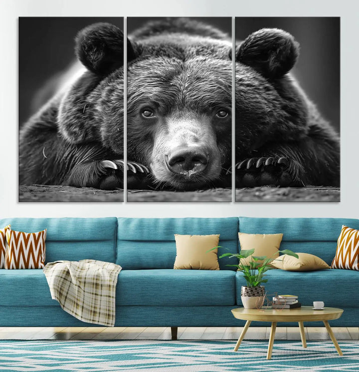 The black and white triptych, titled "Resting Grizzly 399 Bear Canvas Print," is a perfect gift for nature enthusiasts. Displaying a grizzly bear lying down, this wildlife art piece incorporates nautical elements like ships and a diving helmet, adding intriguing details to its rustic cabin and farmhouse decor vibe.