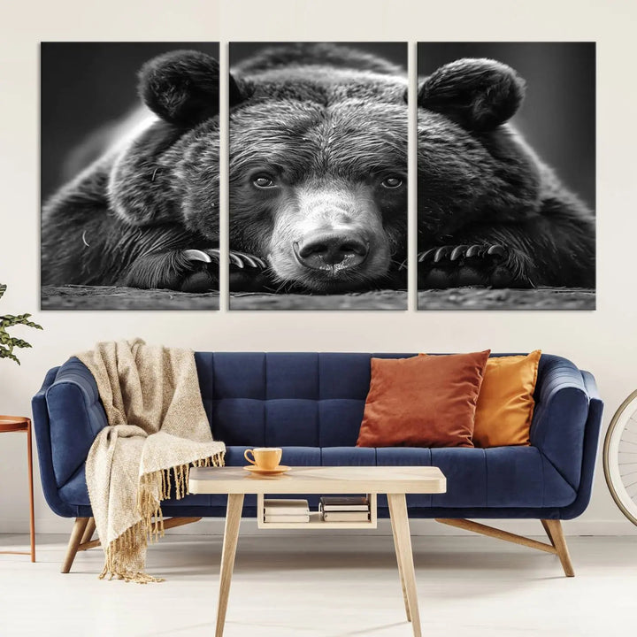 The black and white triptych, titled "Resting Grizzly 399 Bear Canvas Print," is a perfect gift for nature enthusiasts. Displaying a grizzly bear lying down, this wildlife art piece incorporates nautical elements like ships and a diving helmet, adding intriguing details to its rustic cabin and farmhouse decor vibe.