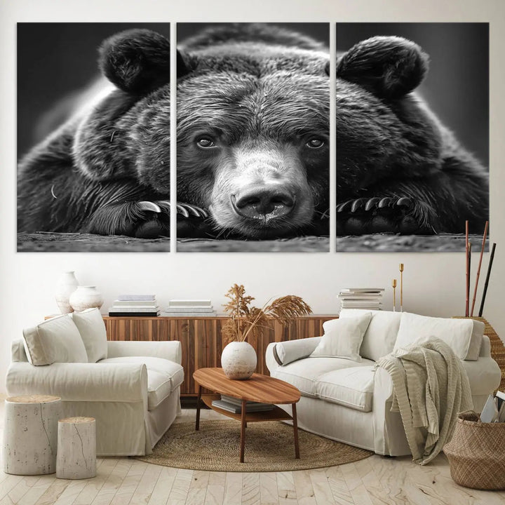 The black and white triptych, titled "Resting Grizzly 399 Bear Canvas Print," is a perfect gift for nature enthusiasts. Displaying a grizzly bear lying down, this wildlife art piece incorporates nautical elements like ships and a diving helmet, adding intriguing details to its rustic cabin and farmhouse decor vibe.