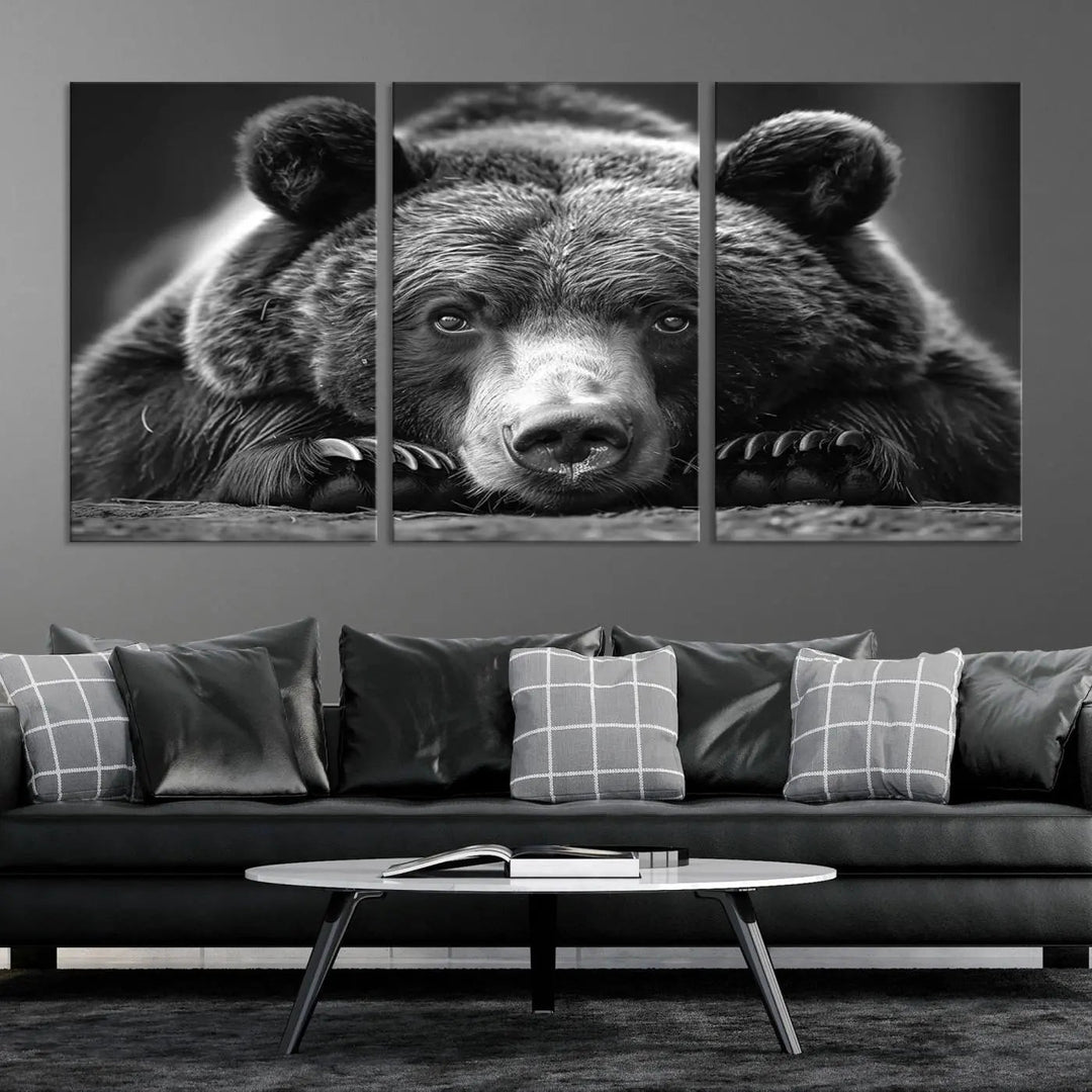 The black and white triptych, titled "Resting Grizzly 399 Bear Canvas Print," is a perfect gift for nature enthusiasts. Displaying a grizzly bear lying down, this wildlife art piece incorporates nautical elements like ships and a diving helmet, adding intriguing details to its rustic cabin and farmhouse decor vibe.