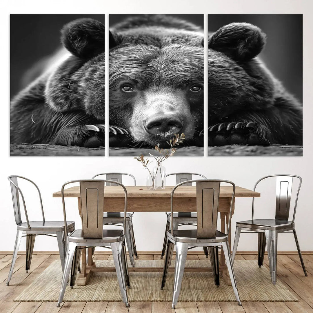 The black and white triptych, titled "Resting Grizzly 399 Bear Canvas Print," is a perfect gift for nature enthusiasts. Displaying a grizzly bear lying down, this wildlife art piece incorporates nautical elements like ships and a diving helmet, adding intriguing details to its rustic cabin and farmhouse decor vibe.