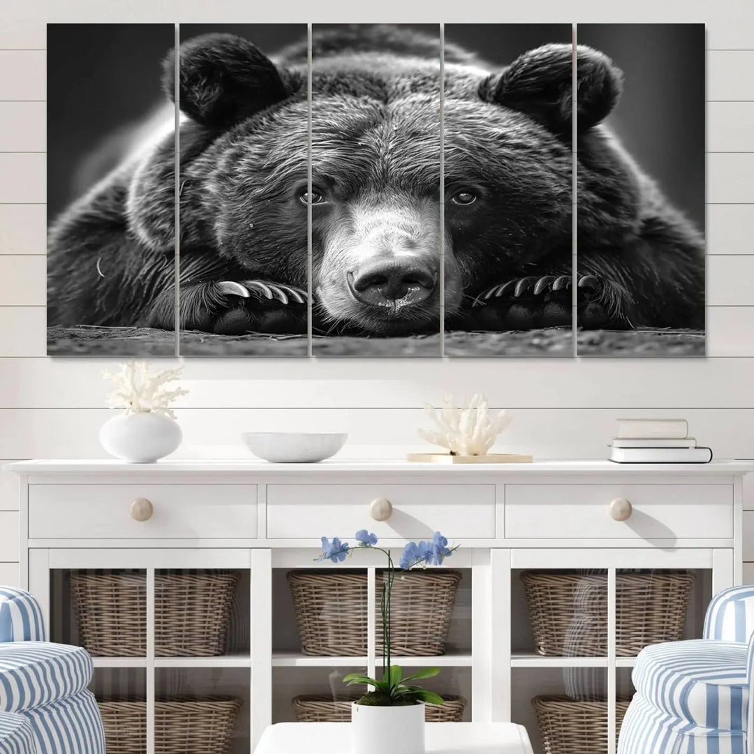 The black and white triptych, titled "Resting Grizzly 399 Bear Canvas Print," is a perfect gift for nature enthusiasts. Displaying a grizzly bear lying down, this wildlife art piece incorporates nautical elements like ships and a diving helmet, adding intriguing details to its rustic cabin and farmhouse decor vibe.