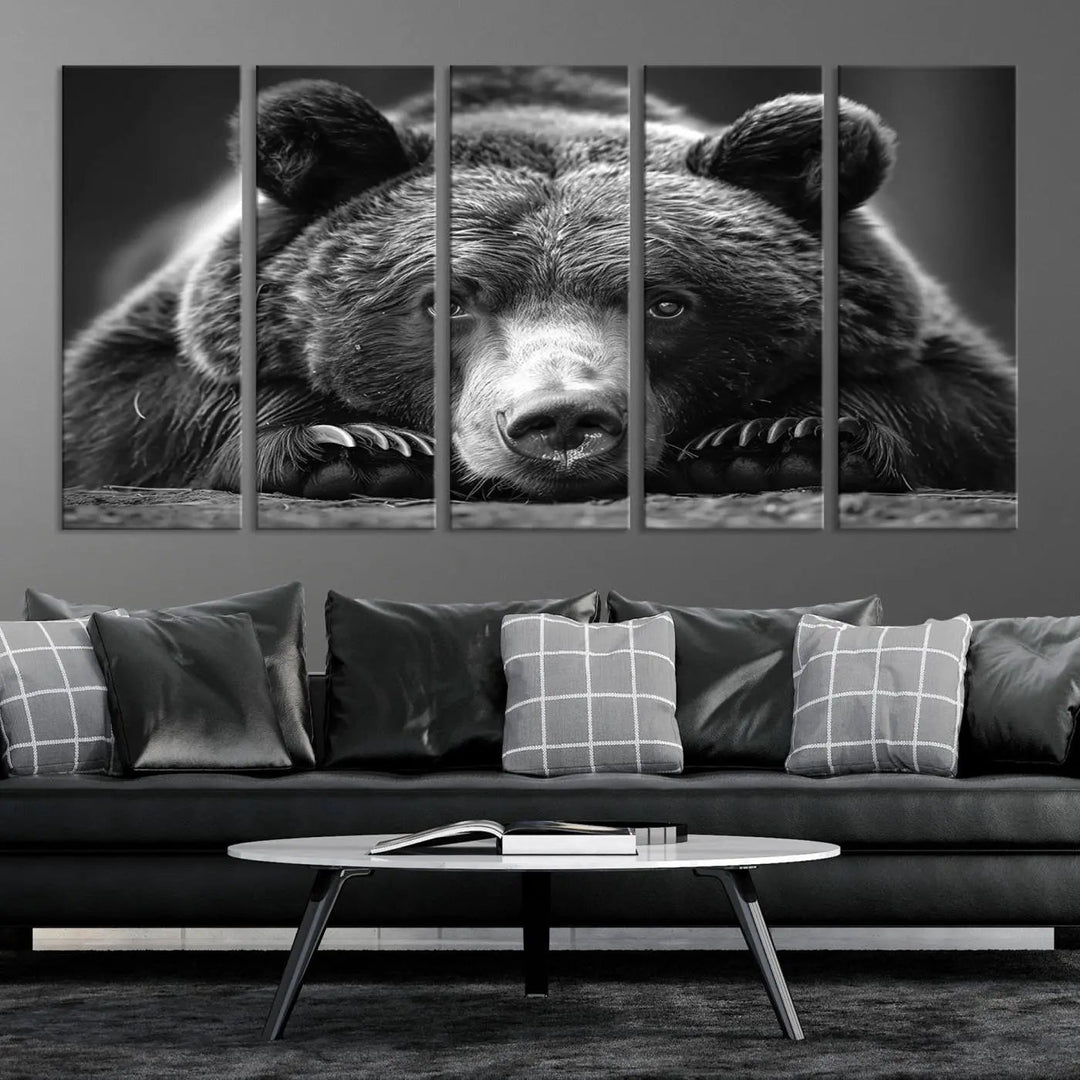 The black and white triptych, titled "Resting Grizzly 399 Bear Canvas Print," is a perfect gift for nature enthusiasts. Displaying a grizzly bear lying down, this wildlife art piece incorporates nautical elements like ships and a diving helmet, adding intriguing details to its rustic cabin and farmhouse decor vibe.