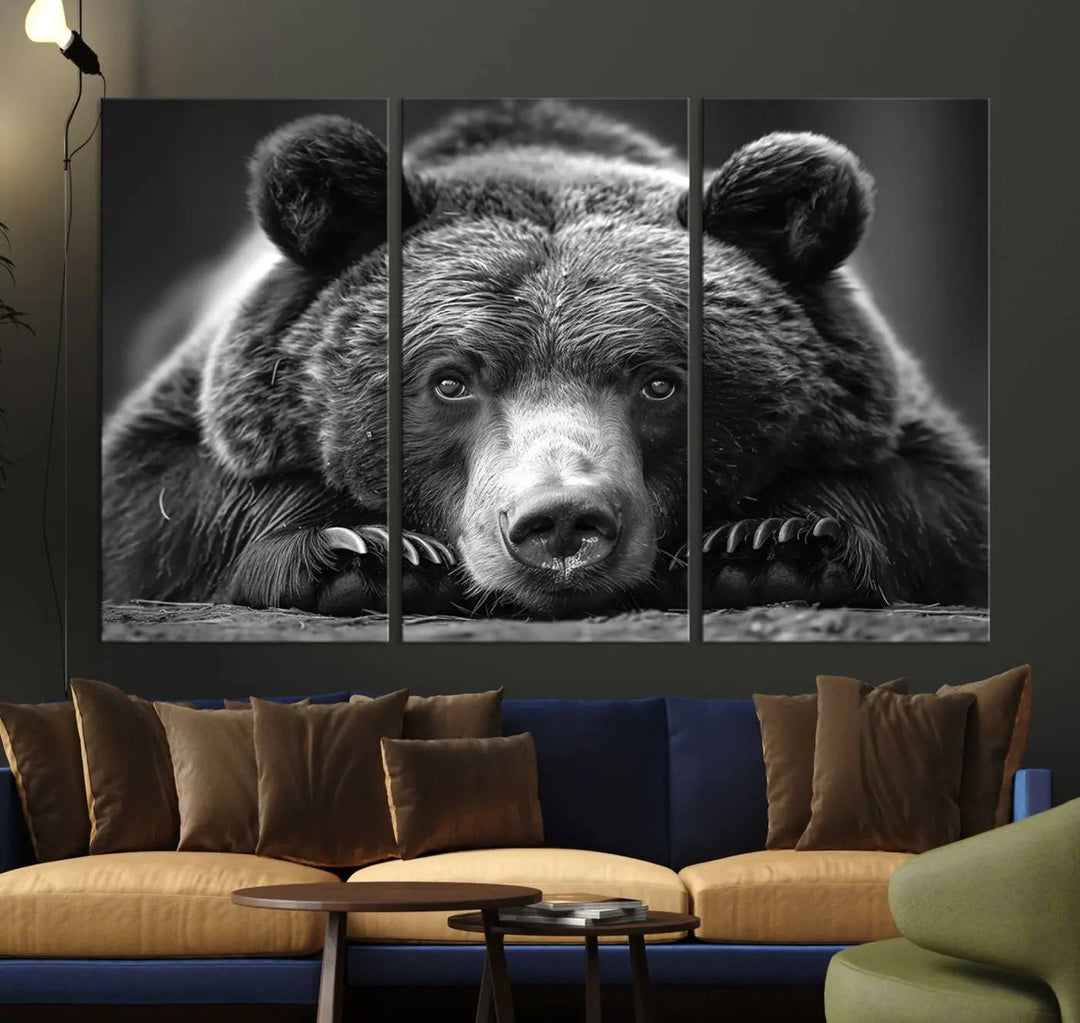 The black and white triptych, titled "Resting Grizzly 399 Bear Canvas Print," is a perfect gift for nature enthusiasts. Displaying a grizzly bear lying down, this wildlife art piece incorporates nautical elements like ships and a diving helmet, adding intriguing details to its rustic cabin and farmhouse decor vibe.