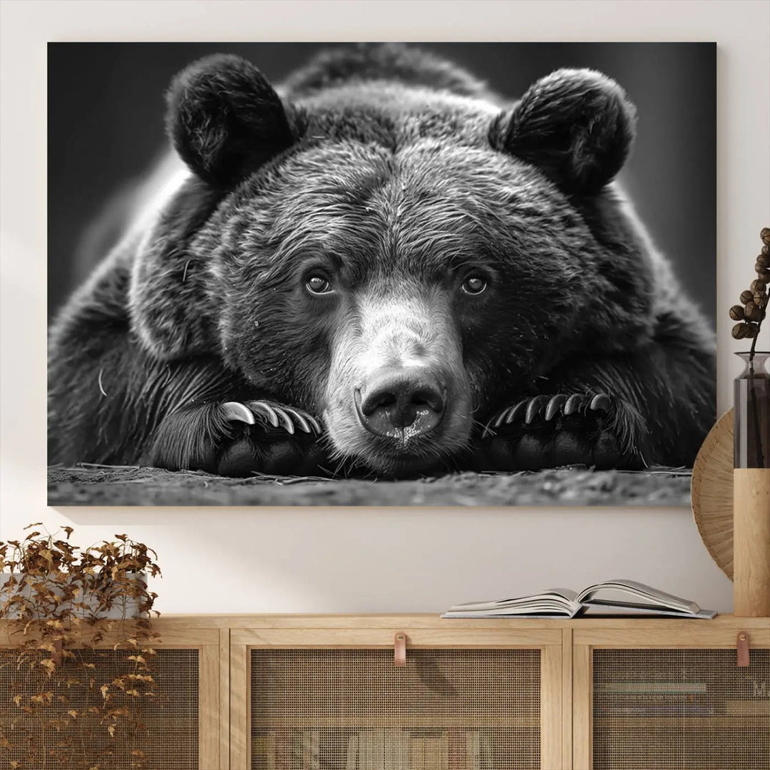 The black and white triptych, titled "Resting Grizzly 399 Bear Canvas Print," is a perfect gift for nature enthusiasts. Displaying a grizzly bear lying down, this wildlife art piece incorporates nautical elements like ships and a diving helmet, adding intriguing details to its rustic cabin and farmhouse decor vibe.