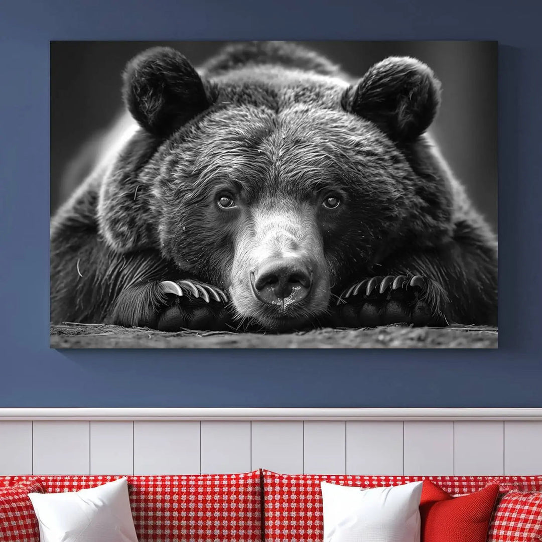 The black and white triptych, titled "Resting Grizzly 399 Bear Canvas Print," is a perfect gift for nature enthusiasts. Displaying a grizzly bear lying down, this wildlife art piece incorporates nautical elements like ships and a diving helmet, adding intriguing details to its rustic cabin and farmhouse decor vibe.