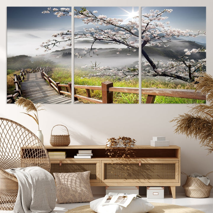 Canvas wall art featuring a scenic wooden walkway surrounded by cherry blossoms and misty mountains, ready to hang.