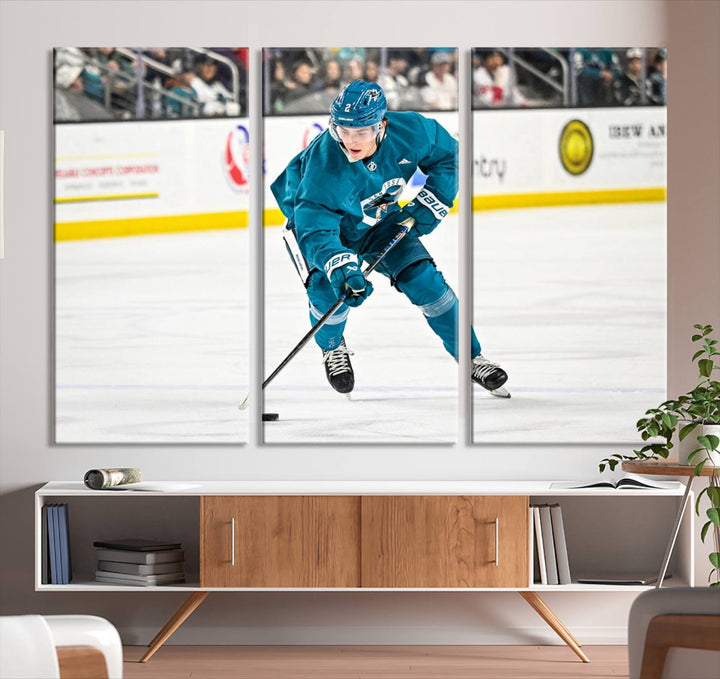 The San Jose Sharks Ice Hockey Player Wall Art Canvas Print beautifully depicts a hockey player in a teal uniform skating with the puck on ice during a game. Captured in vibrant colors and high-resolution, the spectators blur into the background, creating an artwork worthy of museum-quality presentation.