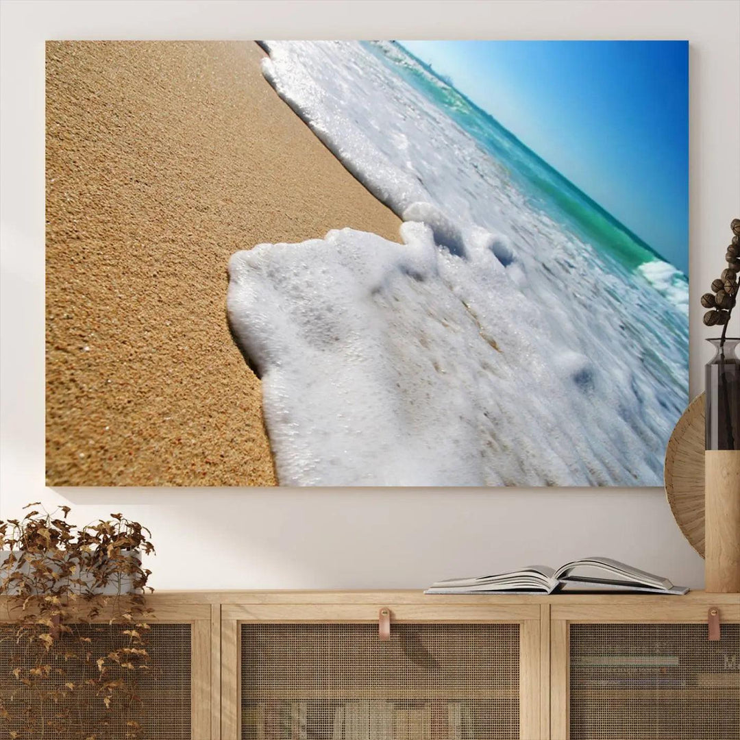 Sandy shoreline close-up ocean wave canvas print. Beach wall art with giclee canvas and gallery wrap, perfect for coastal living decor.