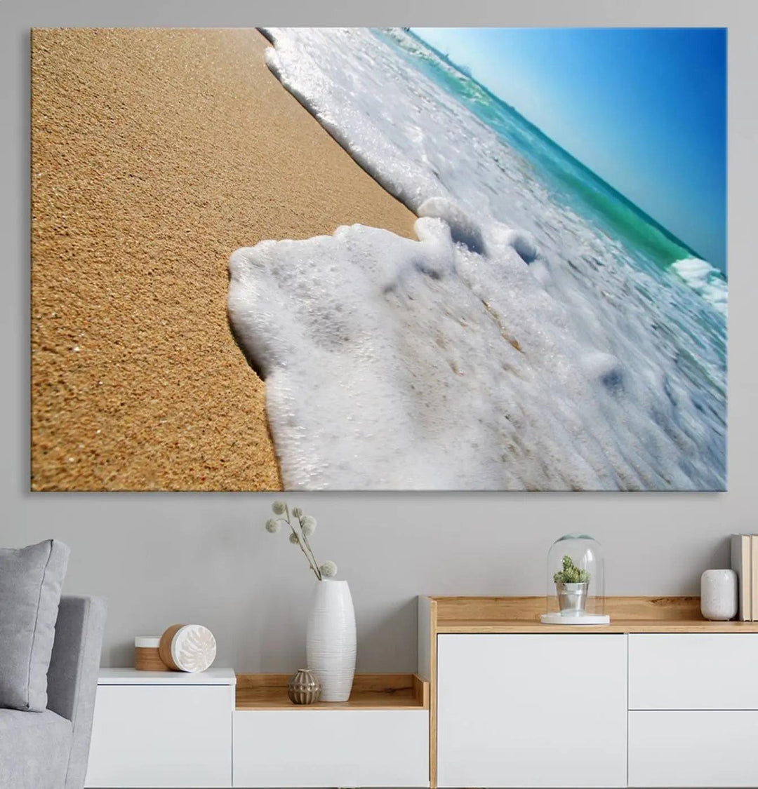 Sandy shoreline close-up ocean wave canvas print. Beach wall art with giclee canvas and gallery wrap, perfect for coastal living decor.