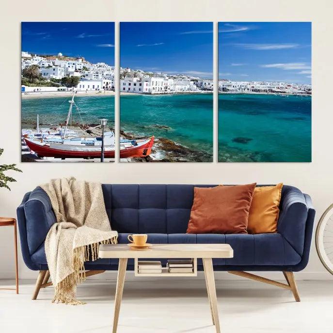 The Santorini Wall Art Canvas Print, showcasing a triptych of a coastal Greek village with white buildings and a turquoise sea, enhances the modern living room.