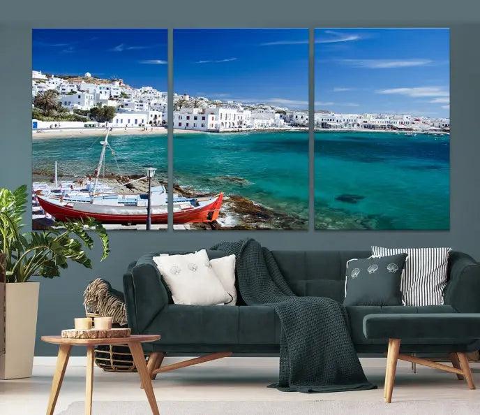 The Santorini Wall Art Canvas Print, showcasing a triptych of a coastal Greek village with white buildings and a turquoise sea, enhances the modern living room.