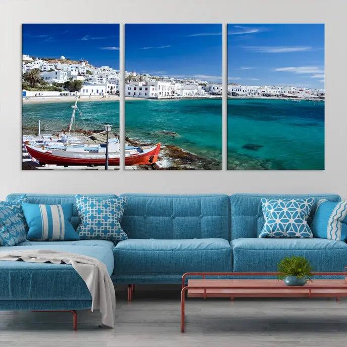 The Santorini Wall Art Canvas Print, showcasing a triptych of a coastal Greek village with white buildings and a turquoise sea, enhances the modern living room.