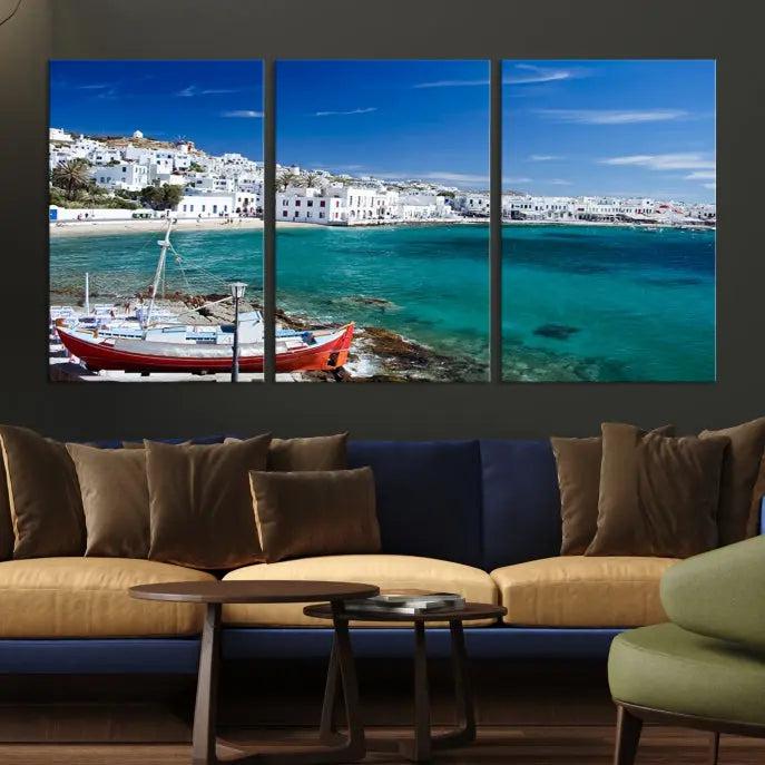 The Santorini Wall Art Canvas Print, showcasing a triptych of a coastal Greek village with white buildings and a turquoise sea, enhances the modern living room.