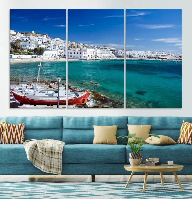 The Santorini Wall Art Canvas Print, showcasing a triptych of a coastal Greek village with white buildings and a turquoise sea, enhances the modern living room.