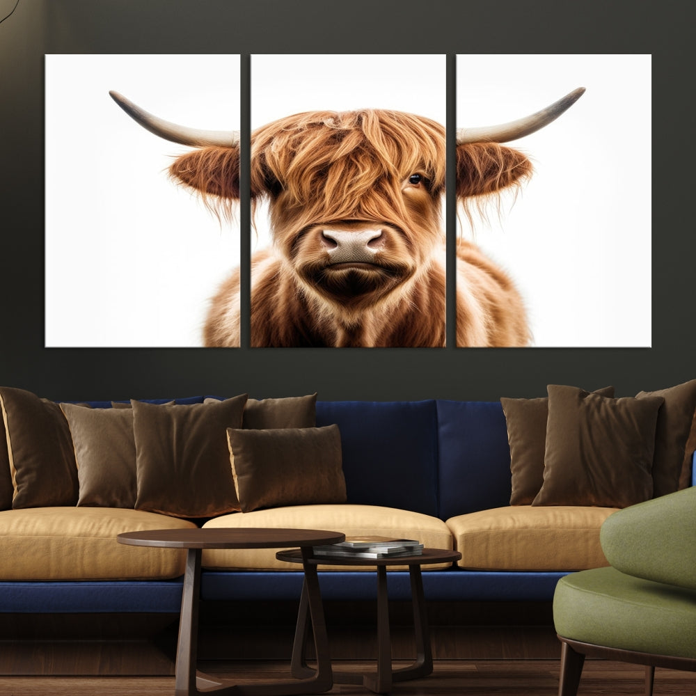 A Scottish Highland Cow Canvas Print, featuring a trio of panels depicting a long-haired, large-horned Highland cow on museum-quality canvas with UV protection, was displayed.