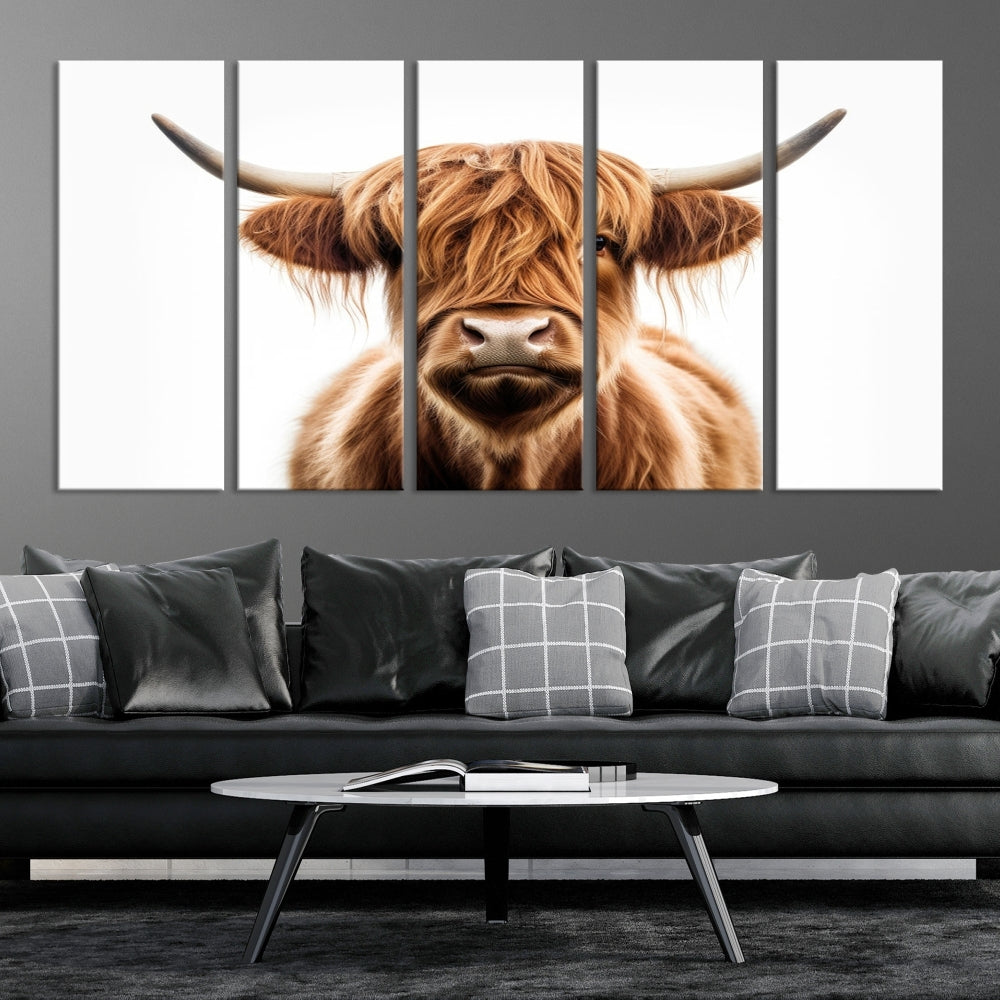 A Scottish Highland Cow Canvas Print, featuring a trio of panels depicting a long-haired, large-horned Highland cow on museum-quality canvas with UV protection, was displayed.