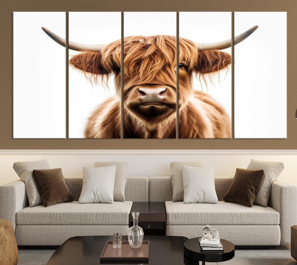 A Scottish Highland Cow Canvas Print, featuring a trio of panels depicting a long-haired, large-horned Highland cow on museum-quality canvas with UV protection, was displayed.