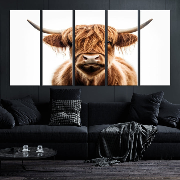 A Scottish Highland Cow Canvas Print, featuring a trio of panels depicting a long-haired, large-horned Highland cow on museum-quality canvas with UV protection, was displayed.