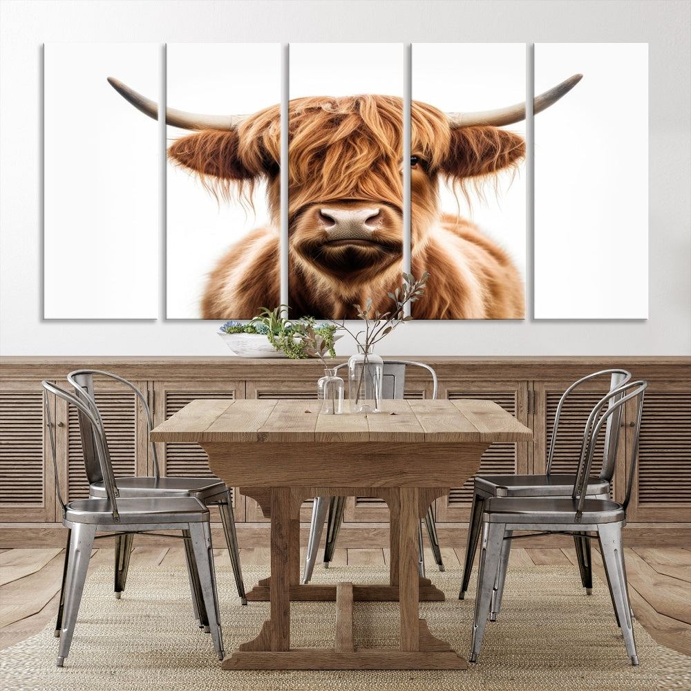 A Scottish Highland Cow Canvas Print, featuring a trio of panels depicting a long-haired, large-horned Highland cow on museum-quality canvas with UV protection, was displayed.