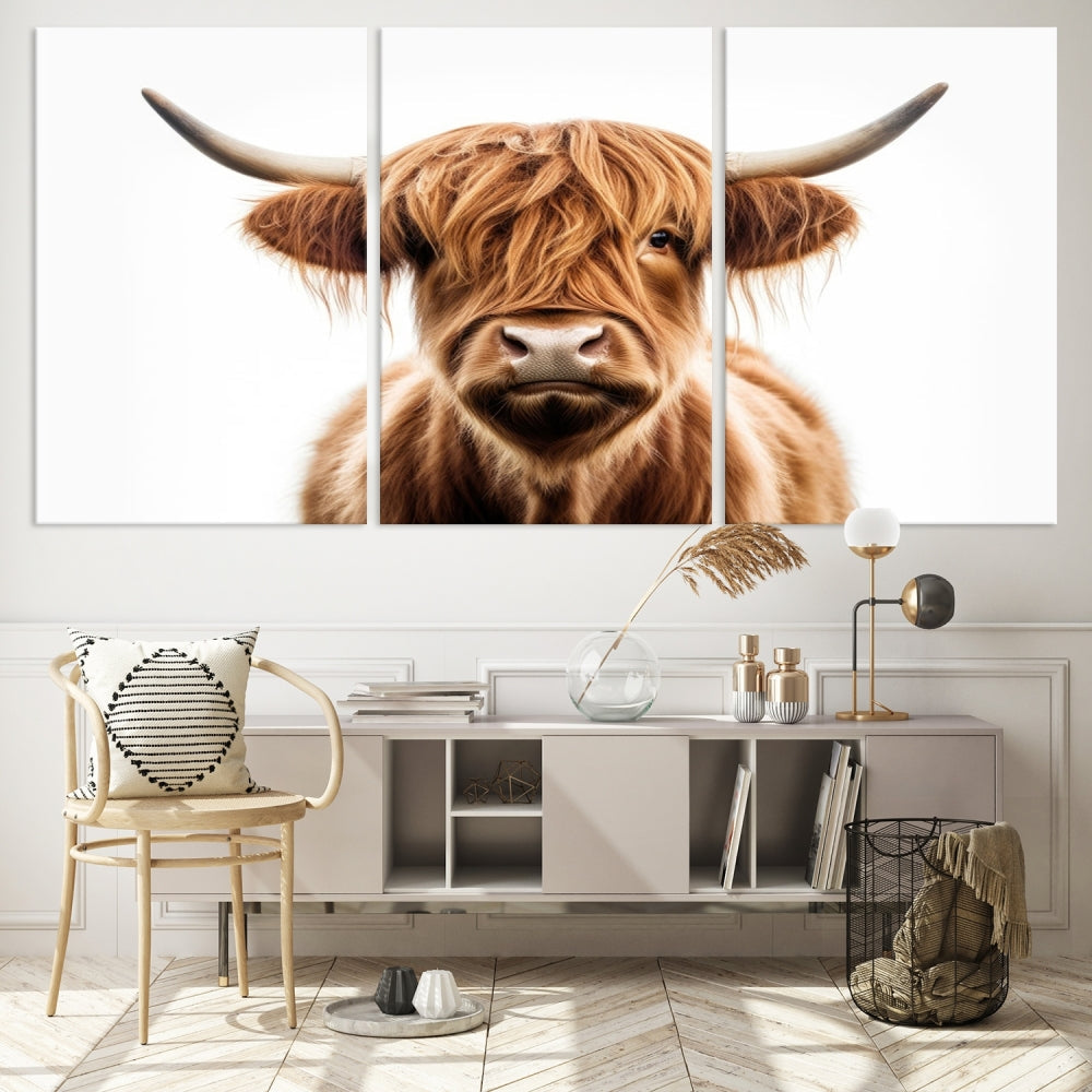 A Scottish Highland Cow Canvas Print, featuring a trio of panels depicting a long-haired, large-horned Highland cow on museum-quality canvas with UV protection, was displayed.