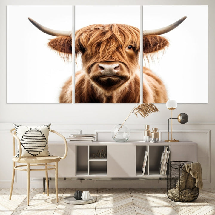 A Scottish Highland Cow Canvas Print, featuring a trio of panels depicting a long-haired, large-horned Highland cow on museum-quality canvas with UV protection, was displayed.