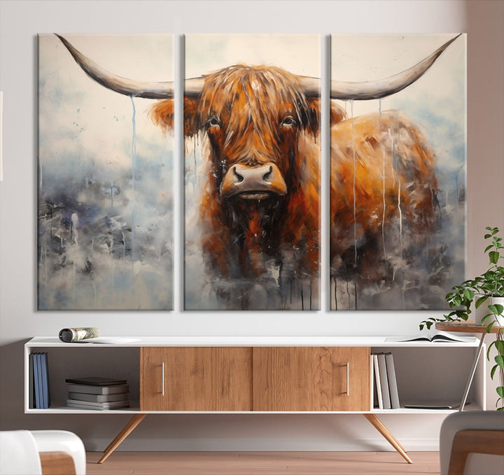 The stunning Scottish Highland Cow Canvas Wall Art enhances the room with its rustic decor. Its three-panel design features a longhorn animal theme, creating a striking presence on the dark wall.