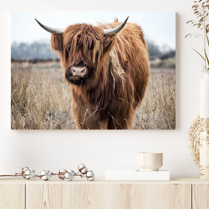 The modern farmhouse aesthetic comes to life with the Scottish Highland Cow Canvas Wall Art, featuring rustic charm and a breathtaking depiction of highland cattle in a natural setting.