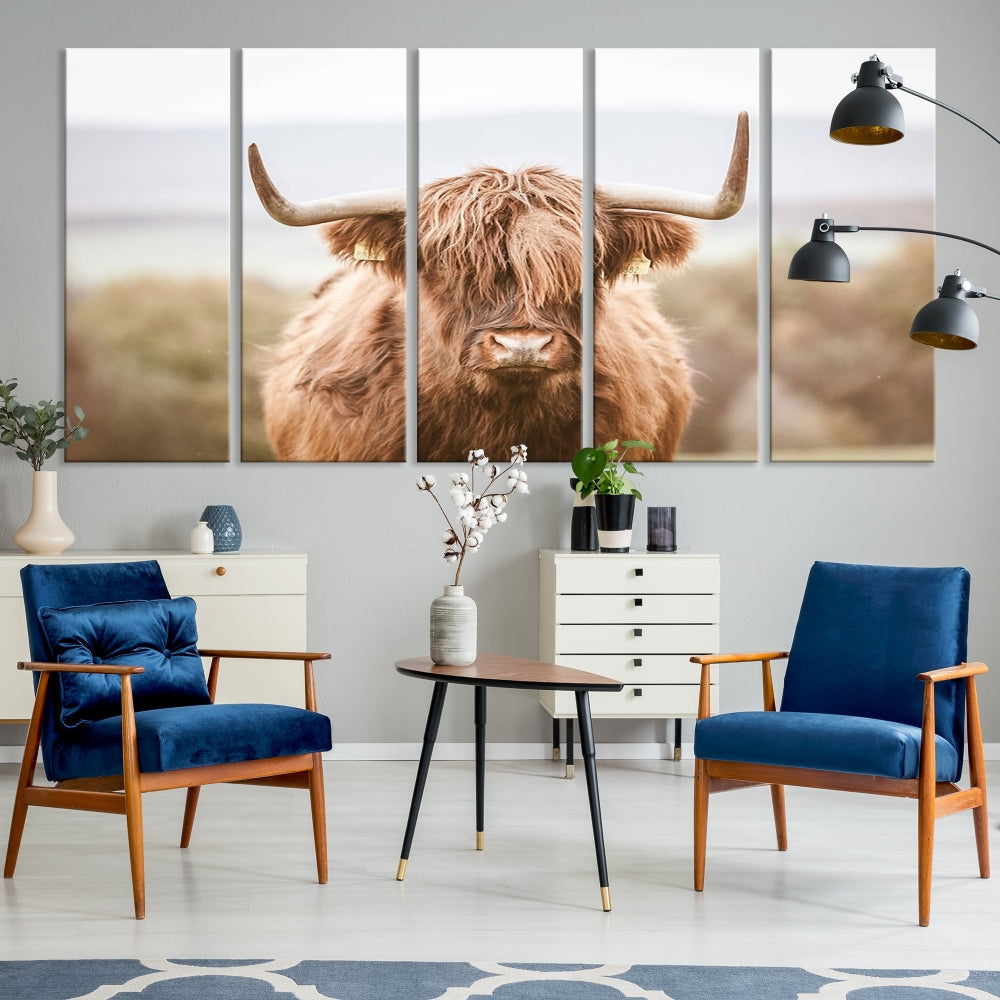 The Scottish Highland Cow Canvas Wall Art features a serene depiction of a Highland cow in natural pastel tones, adding an elegant touch to the farmhouse-inspired decor.